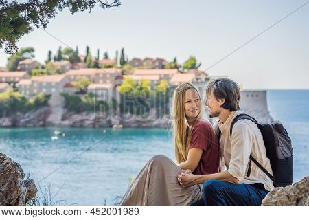 Man And Woman Tourists On Background Of Beautiful View Of The Island Of St. Stephen, Sveti Stefan On