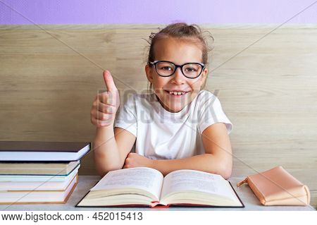 Schoolgirl Girl Reads Books After School To Know A Lot