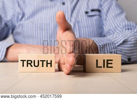 Man Divides Blocks With Words Truth And Lie. Confrontation Between True And False Information, News,