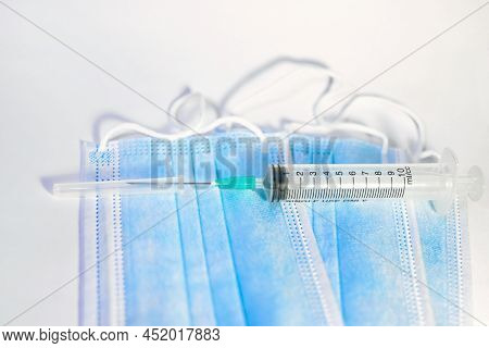 A Blue Mask With A White Background And A Syringe For Injection For Healthcare Workers And People At