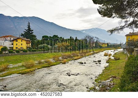 The Sarca River As It Flows Through The Small Town Of Arco On The North Garda Plain On Its Way To La