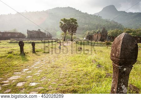 The Ancient Pathway With Sculpture Sandstone Pillars At Vat Phou, Laos. Vat Phou Was A Part Of The K