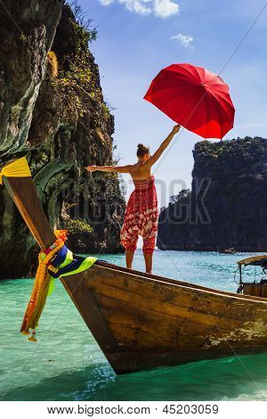 Girl With A Red Umbrella On A Boat At A Resort