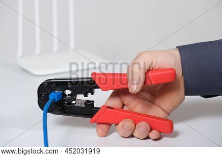 The Computer Master Crimps The Connection Of The Vlan Connector With A Special Tool Crimper.