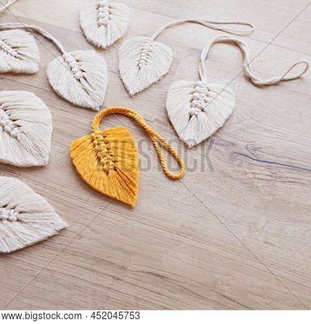 Macrame Leaves In Yellow  And Natural Color On The Wooden Background. Cotton Rope Decor Macrame To M