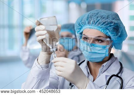 A Medical Worker Prepares A Drip Of Medicen Into For Installation.