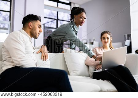 Young Diverse People Using Laptops In Coworking Space
