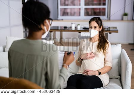 Doula Care And Pregnant Woman Patient At Home