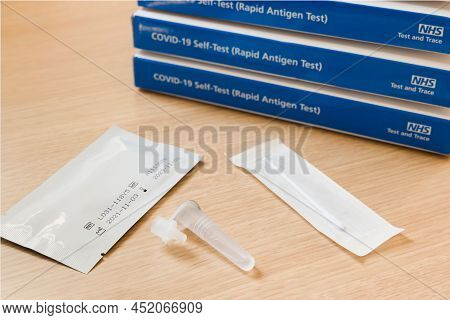 United Kingdom - March 26, 2022. Stack Of Lateral Flow Test Kit Boxes With Contents, Covid-19 Nhs Te