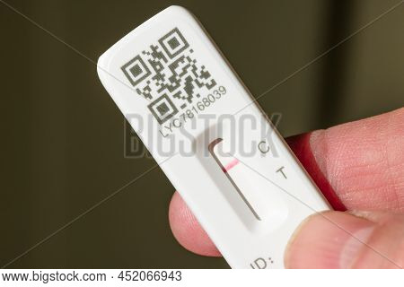 United Kingdom - March 26, 2022. Man Holding A Lateral Flow Test Strip (lft Or Lfd) With Negative Re