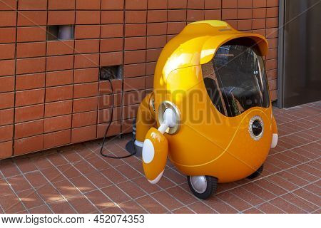 Dubai, Uae - November 28, 2021: Cute Robot Opti, The Guardian Of The Opportunity Pavilion On Charge 