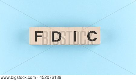 Wooden Cube Block With Text Fdic On Blue Background