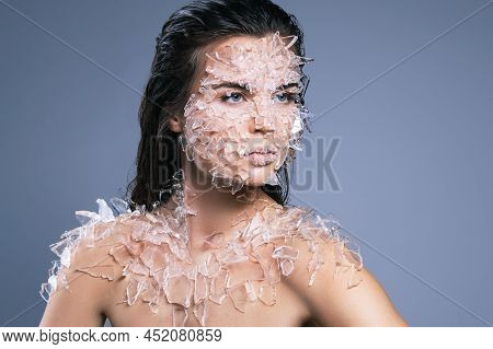 Female Face Covered With A Lot Small Pieces Of Glass Or Ice