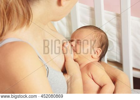 Close-up Of A Woman Breastfeed Newborn Infant Baby Sitting