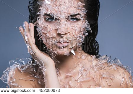 Female Face Covered With A Lot Small Pieces Of Glass Or Ice
