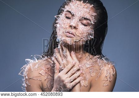 Female Face Covered With A Lot Small Pieces Of Glass Or Ice