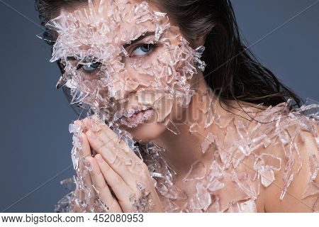 Female Face Covered With A Lot Small Pieces Of Glass Or Ice