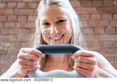 Young Muscular Woman Doing High Pull Exercise With Kettlebells On Hard Training At The Garage Gym. H