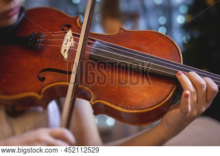 Female Violin Player, Fiddler Violinist With A Bow Performing Music On Stage During Concert With Orc