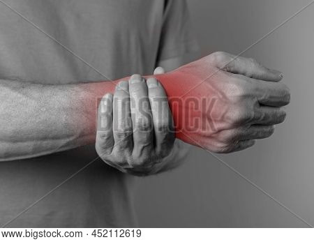 Man Suffering From Wrist Pain And Holding Painful Hand With Red Point. Inflammation Of Tissues, Tend