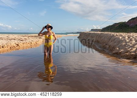Fit Women In A Yellow Bikini At The Beach Known As Pitinga, In Arraial D\' Ajuda, Bahia, Brazil