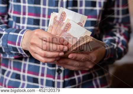 Woman Counts Money. Female Hands Hold Cash Banknotes Denominations Of 5000 Rubles Currency. Business