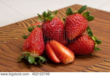Itle
A Beautiful Healthy Strawberry Berries Cut Up On An End Grain Cutting Board Showing The Healthy