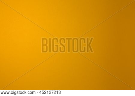 Yellow Is Dark. Paper Background. Illuminated Evenly. Homogeneous.