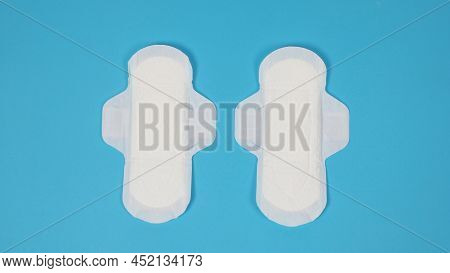 Woman Sanitary Napkins On Blue Background. Top View.