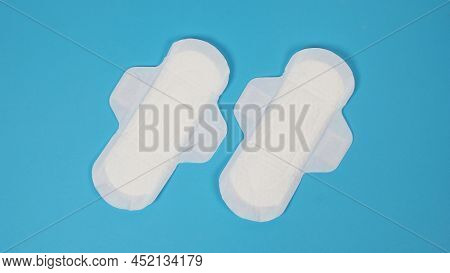 Woman Sanitary Napkins On Blue Background. Top View.