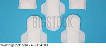 Woman Sanitary Napkins On Blue Background. Top View.