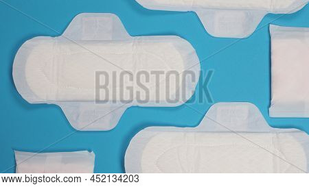 Woman Sanitary Napkins On Blue Background. Top View.
