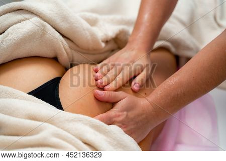 Facial Massage. A Woman Is Given A Massage In A Beauty Salon. Close-up.