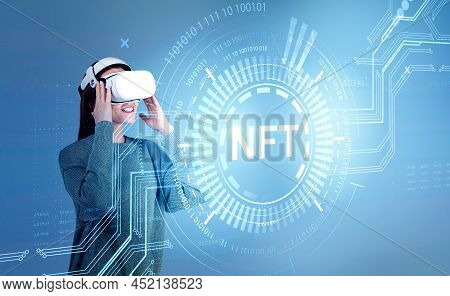 Businesswoman In Formal Wear And Vr Helmet Is Watching At Digital Interface With Non-fungible Token 