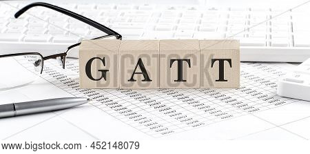 Gatt Written On Wooden Cube With Keyboard , Calculator, Chart,glasses.business