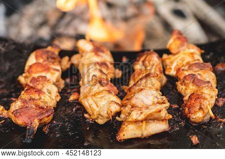 Preparing Chicken Meat Skewers, Grilled Or Roasted In A Barbecue On An Open Fire And Flames, Shashli