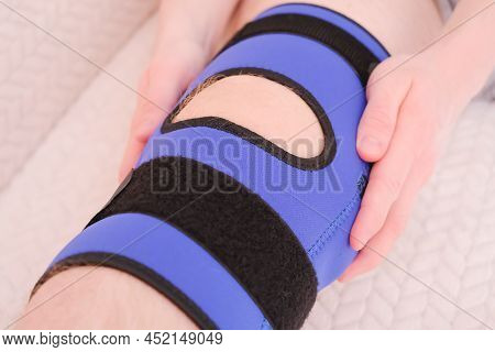 Blue Bandage On The Knee Joint, Orthosis On The Knee Joint After Injury Or Surgery. Close-up, Male K