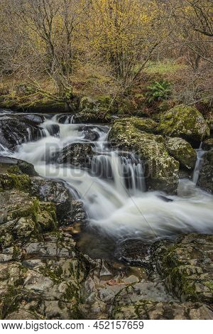 Epic Landscape Image Of Aira Force Upper Falls In Lake District During Colorful Autumn Showing