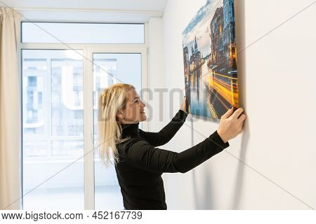Photo Canvas Print. A Woman Holding A Photography With Gallery Wrap. Photo Printed On Glossy Synthet
