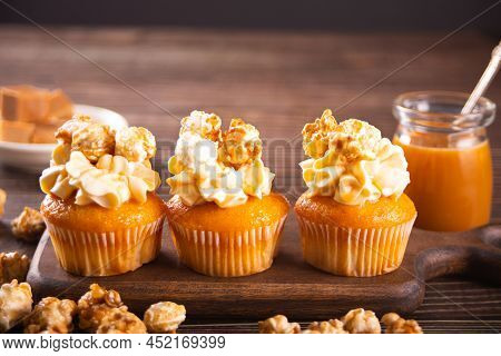 Homemade Cupcakes With Caramel Syrup With Whipped Cream Cheese And Candy Toffie Caramel Popcorn Deco