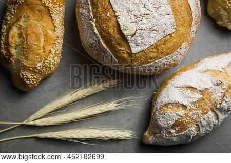 Beautiful Sourdough Bread On Gray Background With Dried Wheat Flower