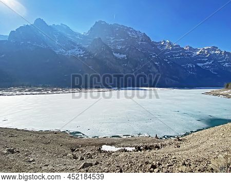 Frozen Klöntalersee Or Klontaler Lake During Early Spring In The Alpine Valley Klöntal (kloental Or 