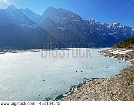 Frozen Klöntalersee Or Klontaler Lake During Early Spring In The Alpine Valley Klöntal (kloental Or 