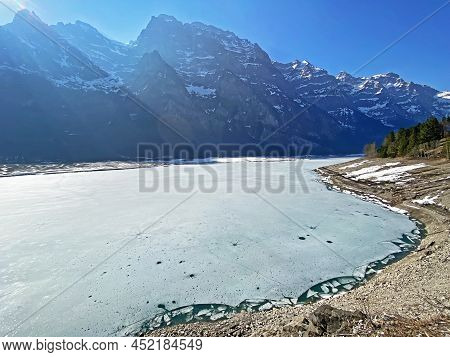 Frozen Klöntalersee Or Klontaler Lake During Early Spring In The Alpine Valley Klöntal (kloental Or 