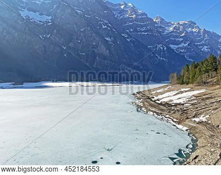 Frozen Klöntalersee Or Klontaler Lake During Early Spring In The Alpine Valley Klöntal (kloental Or 