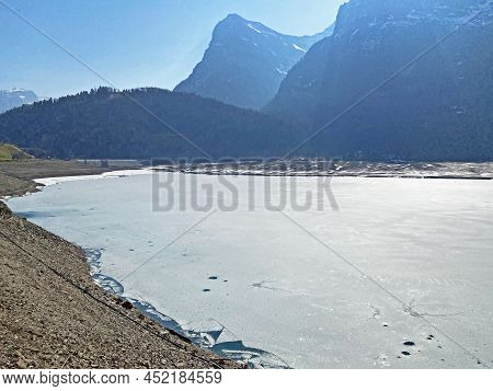 Frozen Klöntalersee Or Klontaler Lake During Early Spring In The Alpine Valley Klöntal (kloental Or 