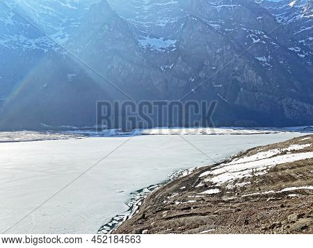 Frozen Klöntalersee Or Klontaler Lake During Early Spring In The Alpine Valley Klöntal (kloental Or 