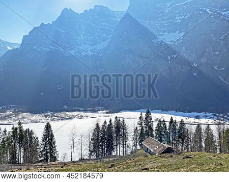 Frozen Klöntalersee Or Klontaler Lake During Early Spring In The Alpine Valley Klöntal (kloental Or 