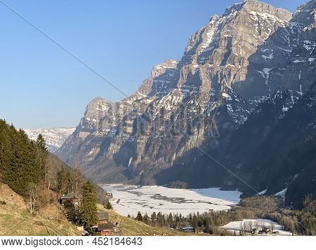 Frozen Klöntalersee Or Klontaler Lake During Early Spring In The Alpine Valley Klöntal (kloental Or 