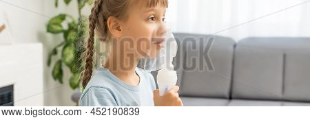 Little Girl Making Inhalation With Nebulizer At Home. Child Asthma Inhaler Inhalation Nebulizer Stea
